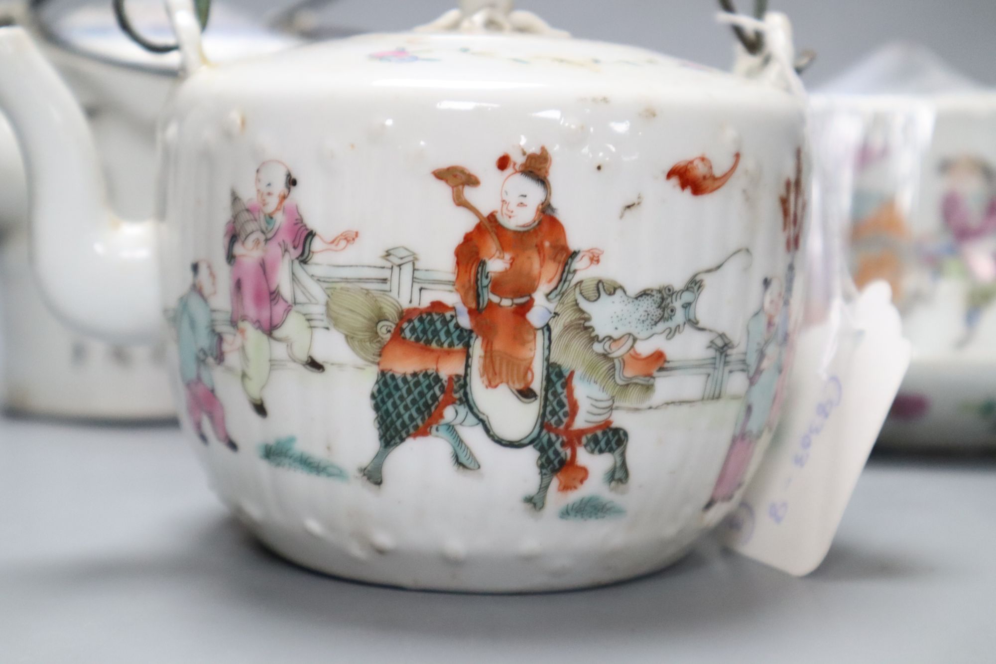 Two Chinese famille rose teapots and covers, and a calligraphic teapot, tallest 10cm